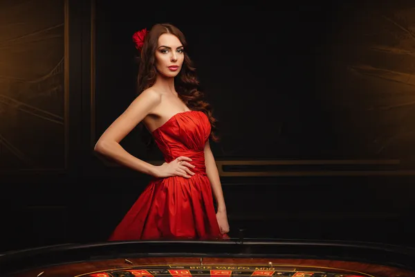 A young woman relaxing with her phone while dynamic casino elements float around her, illustrating the smooth mobile experience offered by the JILIX app.