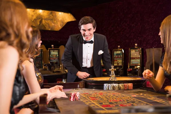 A stylish woman beside vibrant slot machines displaying glowing sevens, showcasing the variety of top slots at JILIX.